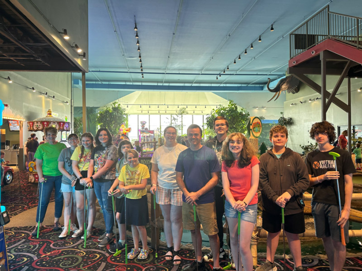 Temple Youth pose inside Walther's Golf and Fun with their leaders